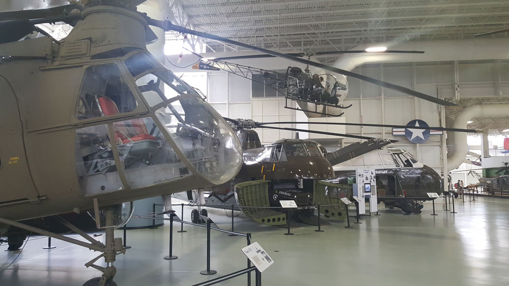 Four helicopter exhibits inside the U.S. Army Aviation Museum.